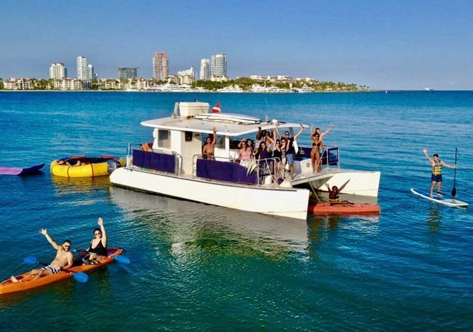 People having fun celebrating on a private party catamaran charter in Miami